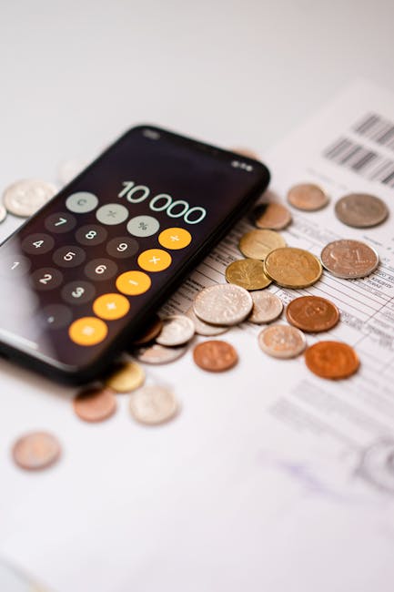 Phone calculator and coins for financial mindfulness